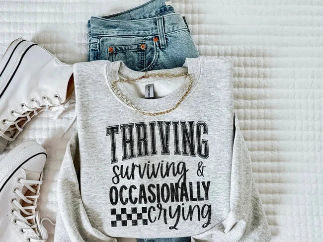 THRIVING SURVIVING AND OCCASIONALLY CRYING